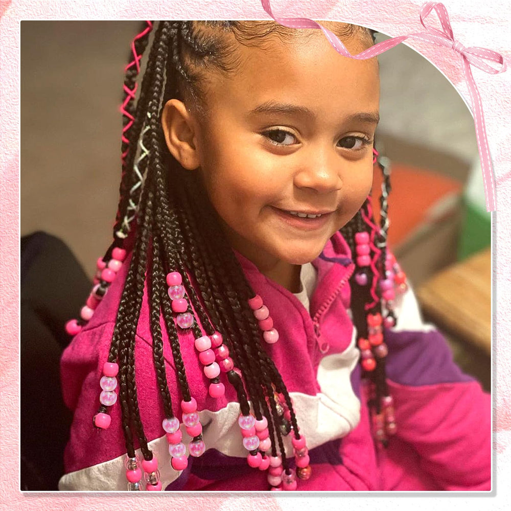 NAISKA beads clipped on child’s braid adding playful colorful detail