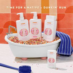 Person rinsing hair with Native shampoo in shower showing effective everyday use benefit