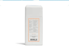 Native travel size Sweet Peach & Nectar bottle held in hand to show compact travel-friendly scale