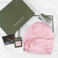 NatureKess pink bonnet styled in lounge setting benefit: fashionable at home