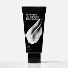 Nécessaire creamy lotion texture close-up demonstrating fast-absorbing, non-greasy finish