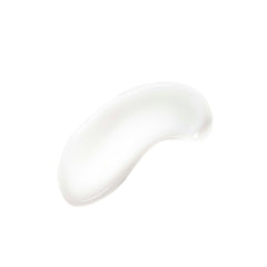 Applying micellar milk with a cotton pad to eye area for gentle makeup removal