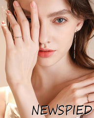 NEWSPIED nails beside a coin showing scale and realistic medium thickness