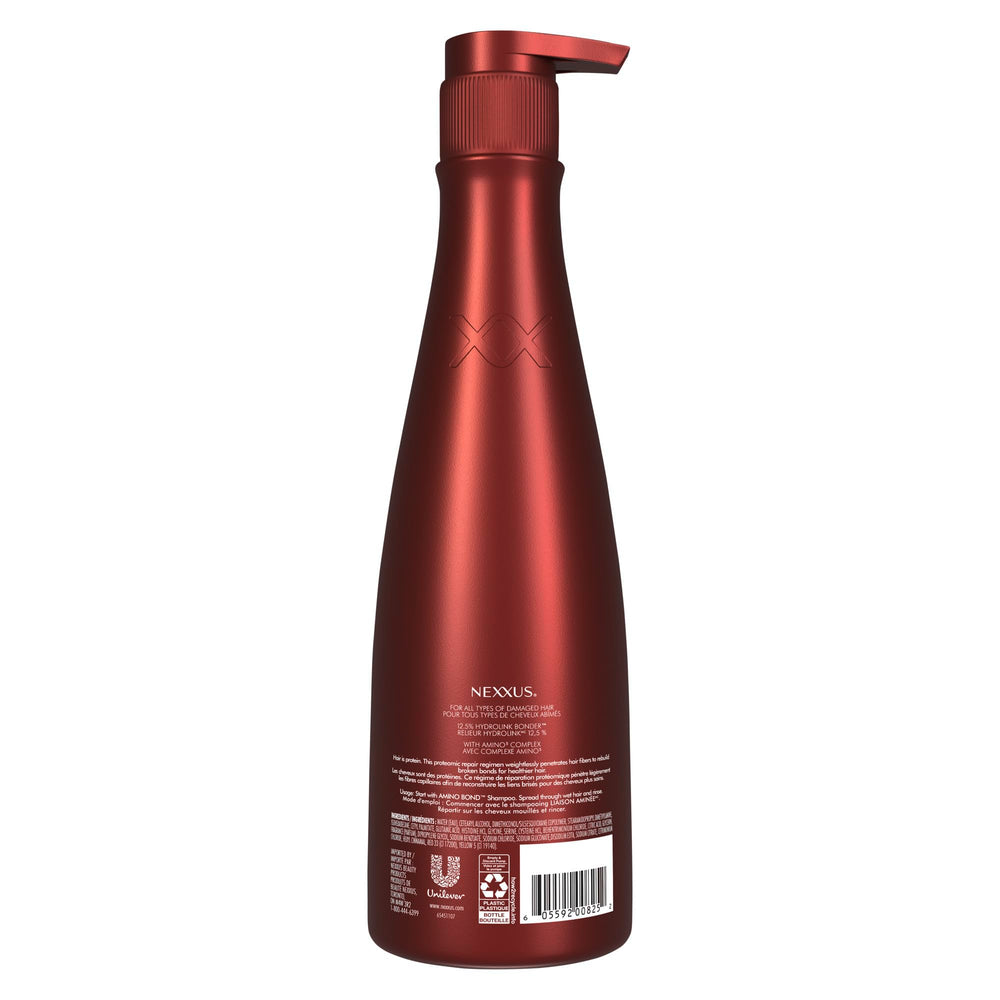Nexxus 13.5 oz bottle beside hand to display scale and travel-friendly size