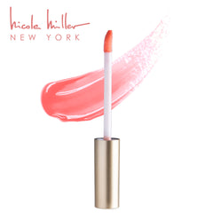 Nicole Miller gloss held in hand to show size and portability for on-the-go touch ups