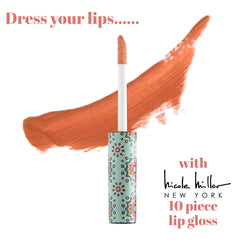 Nicole Miller New York lip gloss tube beside a coin for size and travel convenience
