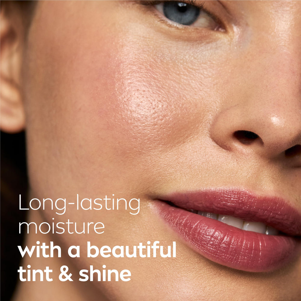 NIVEA strawberry balm swirled on hand highlighting creamy texture and nourishing oils