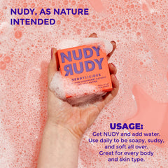 Nudy Rudy bar in hand for scale, conveys compact travel-friendly size