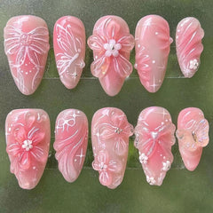 NZRAESTRS front packaging showing 24 pink almond press-on nails with accessories for a complete set
