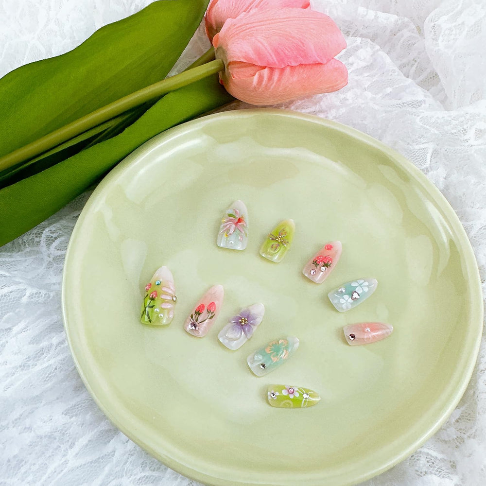 NZRAESTRS nails worn on hand lifestyle image demonstrating wearable almond shape and charm