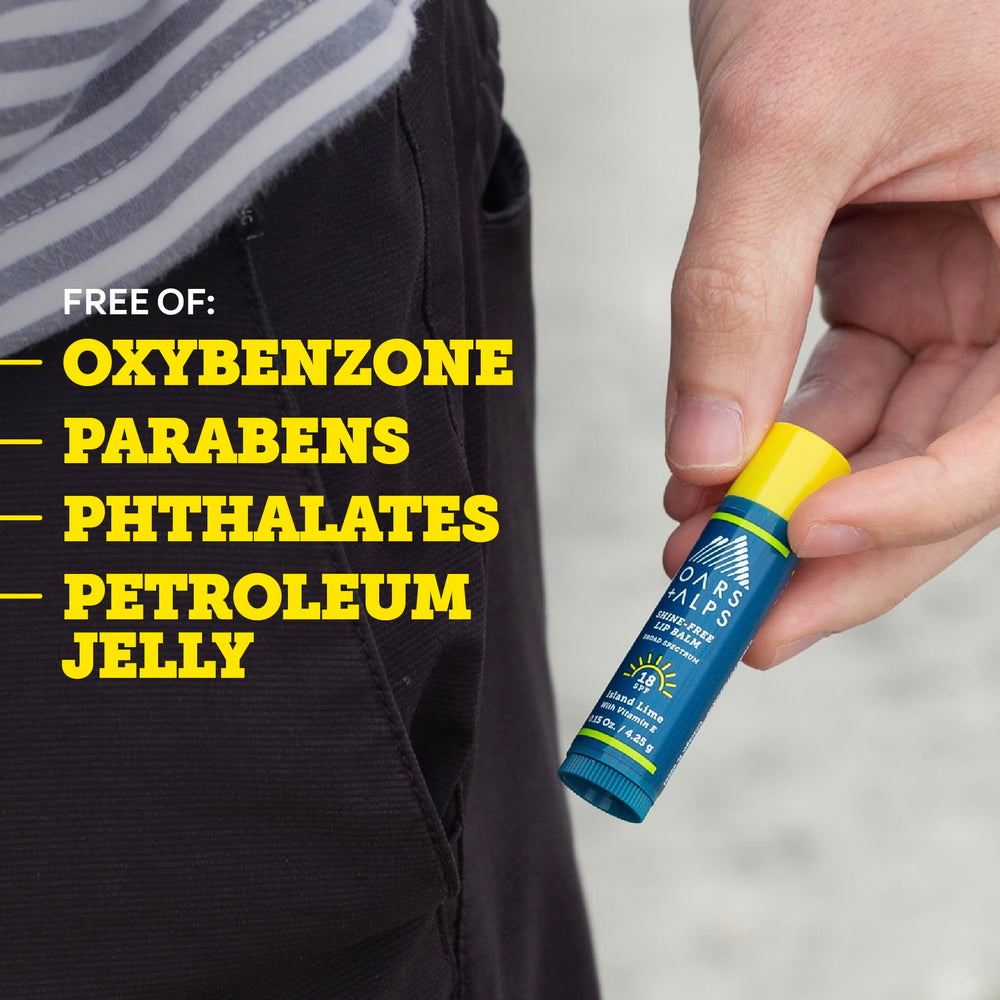 Oars + Alps lip sunscreen on a towel at beach showing outdoor protection