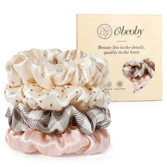 obeoby front packaging showing four patterned silk scrunchies, ready to gift and wear