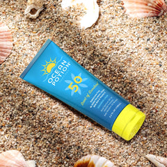Ocean Potion bottle beside sunglasses showing compact travel-friendly size