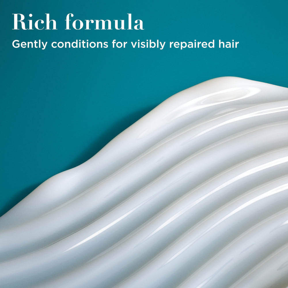 OGX conditioner texture on palm demonstrating smooth, spreadable benefit