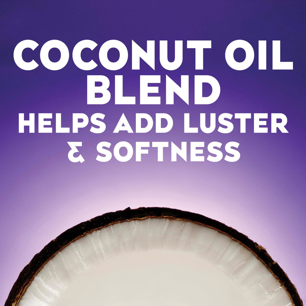 OGX shampoo being applied in shower to tame frizz effectively