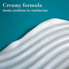 Person applying OGX conditioner in shower showing detangling and clarifying benefit