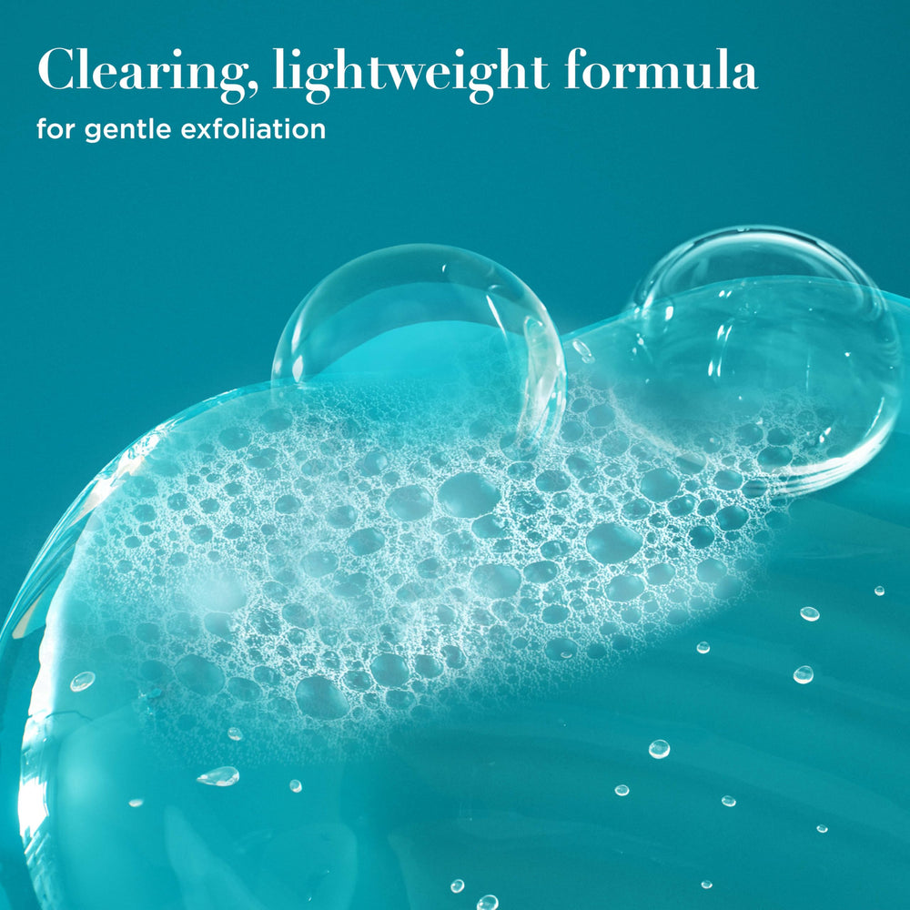 Close-up of OGX ProGrowth creamy texture showing exfoliating consistency