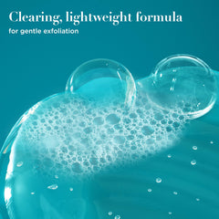 Close-up of OGX ProGrowth creamy texture showing exfoliating consistency
