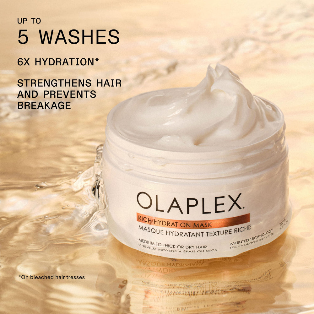 Olaplex mask being applied to damp hair demonstrating improved hydration