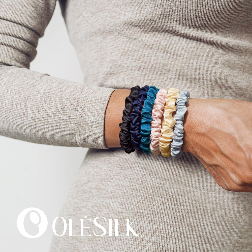 OLESILK scrunchie beside a coin showing scale and discreet slim profile benefit
