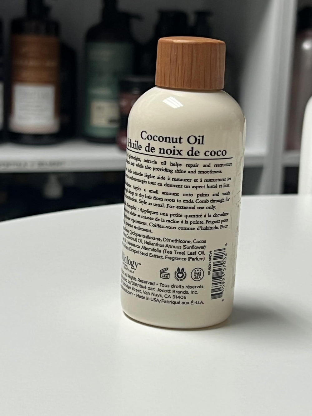 applying Oliology oil to mid-lengths to tame frizz and add shine