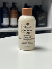 drop of Oliology oil on hand showing lightweight texture and absorption