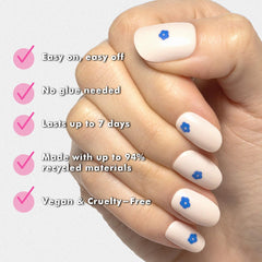 Olive & June application demo on a hand model showing easy glue-free adhesion