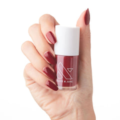 Olive & June bottle front view showing Cozy Up Brick Red shade and benefits
