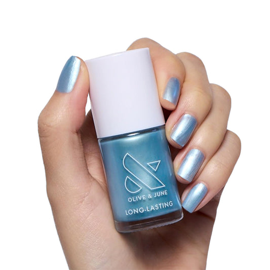 Olive & June bottle front view showing shimmery blue polish and glossy appeal