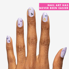 Olive & June applying sticker to nail demonstrating easy at-home use