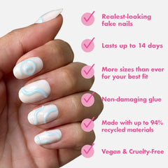 Olive & June nails held in hand to show size and wearable scale benefits