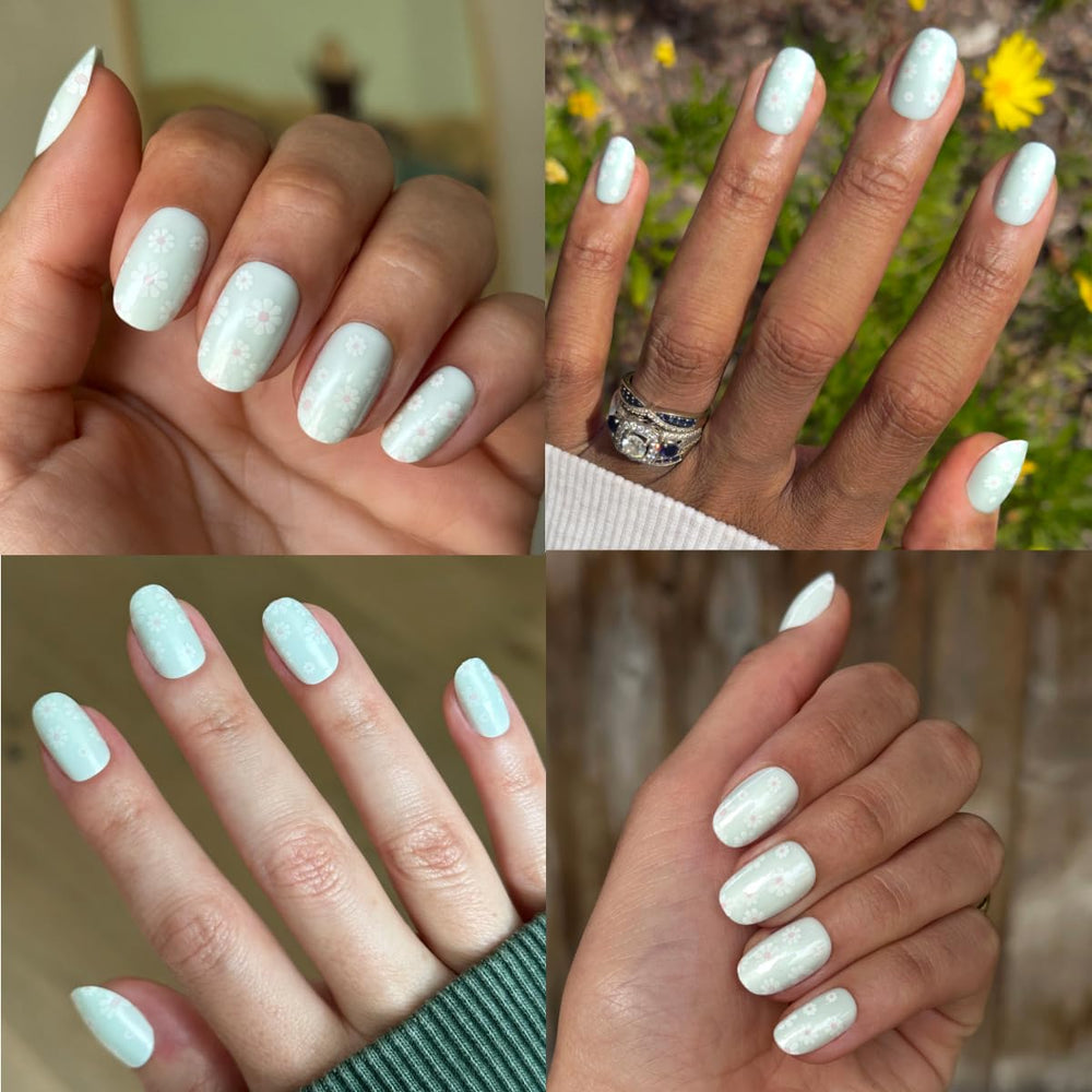 Olive & June press-on nails worn on hand displaying bold teal chrome manicure