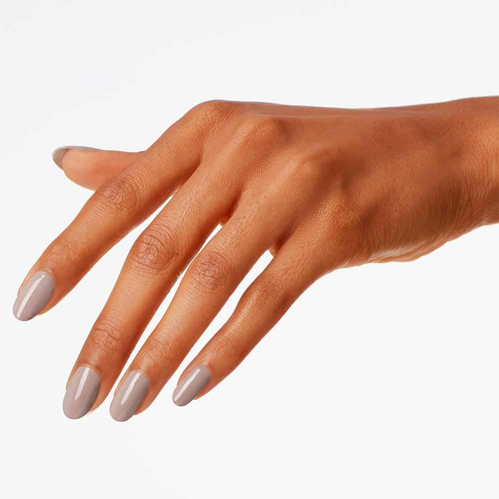 Model hand wearing icelanded a bottle of opi showing opaque coverage and wearable style benefit