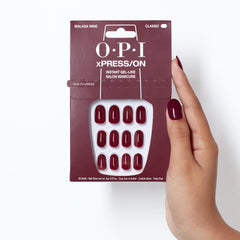 OPI lifestyle scene of Malaga Wine nails at evening event showing elegant style