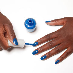 OPI Nature Strong lifestyle shot by the shore showing color inspiration and wearable style benefit
