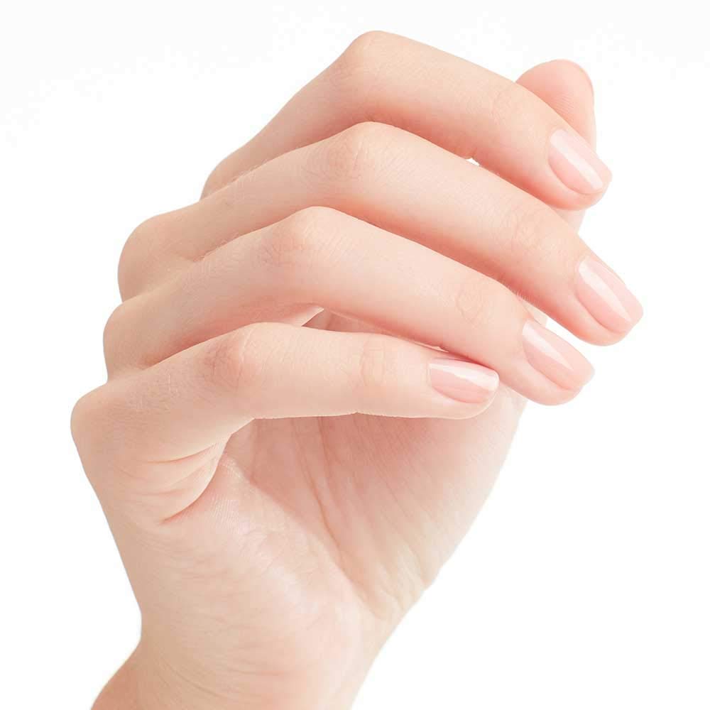 Hand holding OPI Passion bottle to show size and everyday portability
