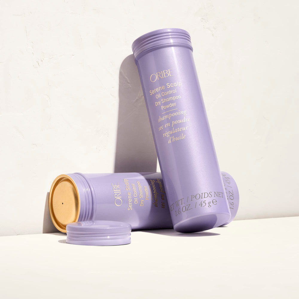 ORIBE bottle beside a coin showing compact travel size and convenient portability