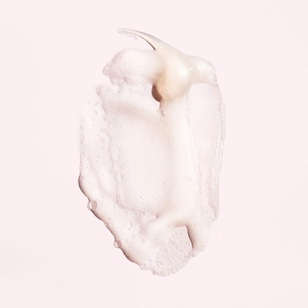 Oribe shampoo texture close-up demonstrating gentle cleansing