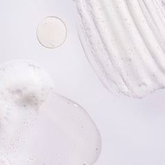 ORIBE shampoo lather texture close-up highlighting gentle cleansing action