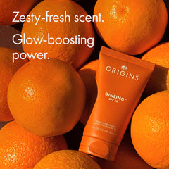 Origins GinZing beside a ruler to show 1.7 fl oz size and portability