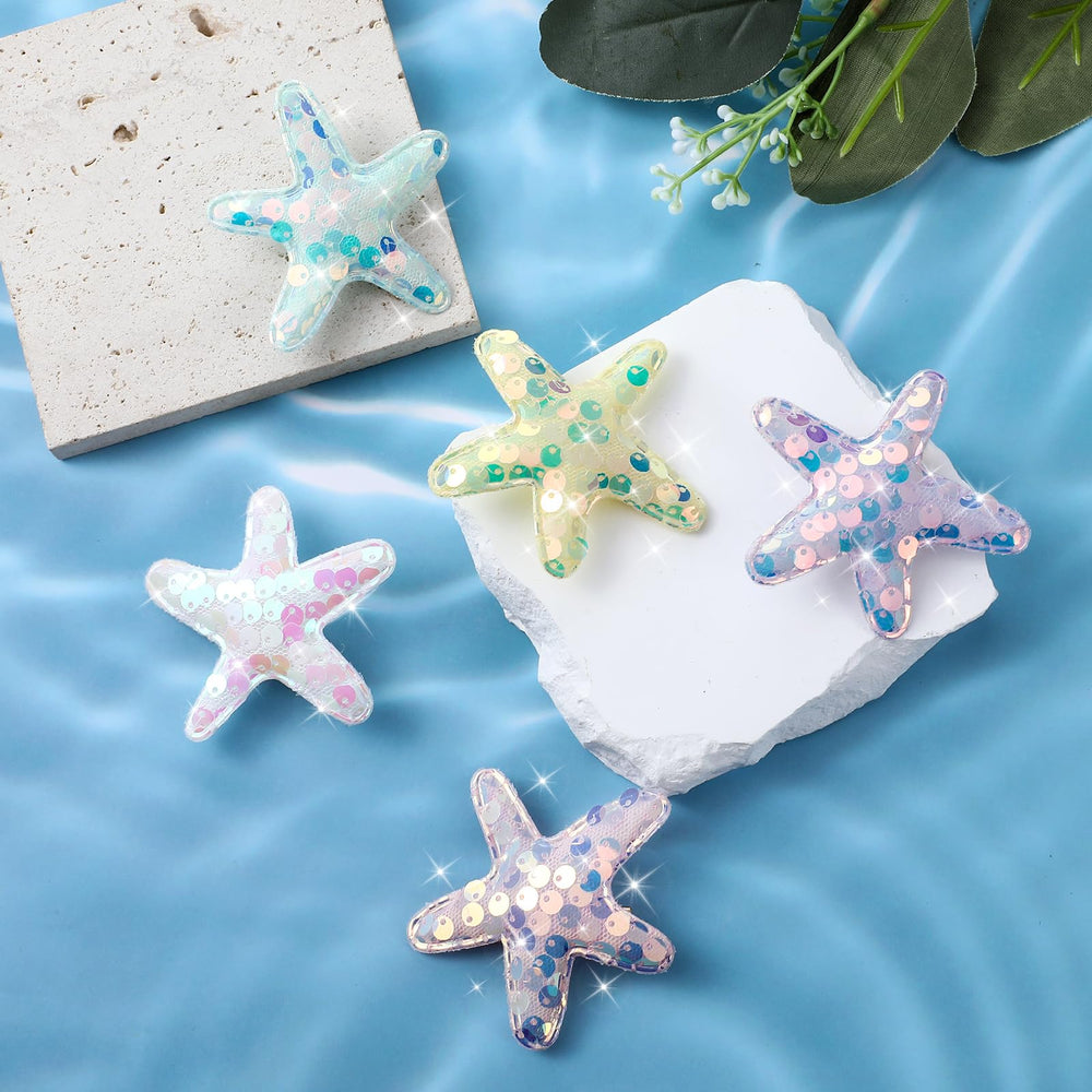 Oruola starfish clip beside coin showing compact 6x6 cm size advantage
