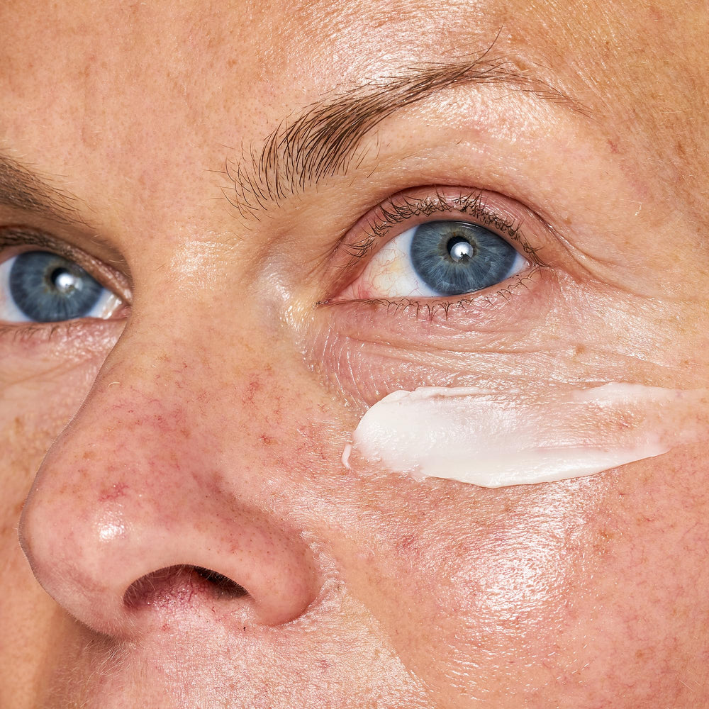 OSEA applying eye cream on hand to demonstrate lightweight spread and absorption