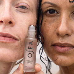 OSEA Ocean Eyes size comparison in hand illustrating compact travel-friendly design