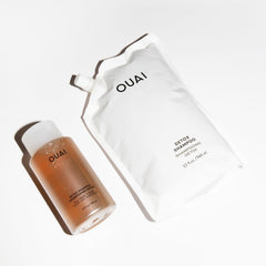 OUAI detox shampoo 32 oz held in hand shows refill size and value benefit