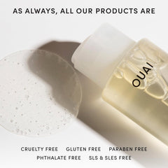 OUAI 10 oz bottle in hand for scale, showing travel-safe volume