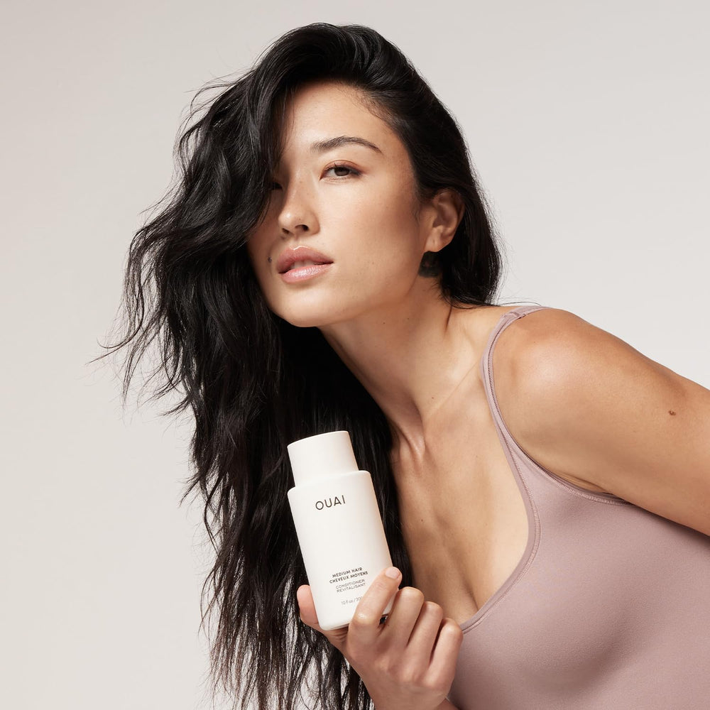 OUAI medium conditioner creamy texture close-up demonstrating smooth slip for detangling
