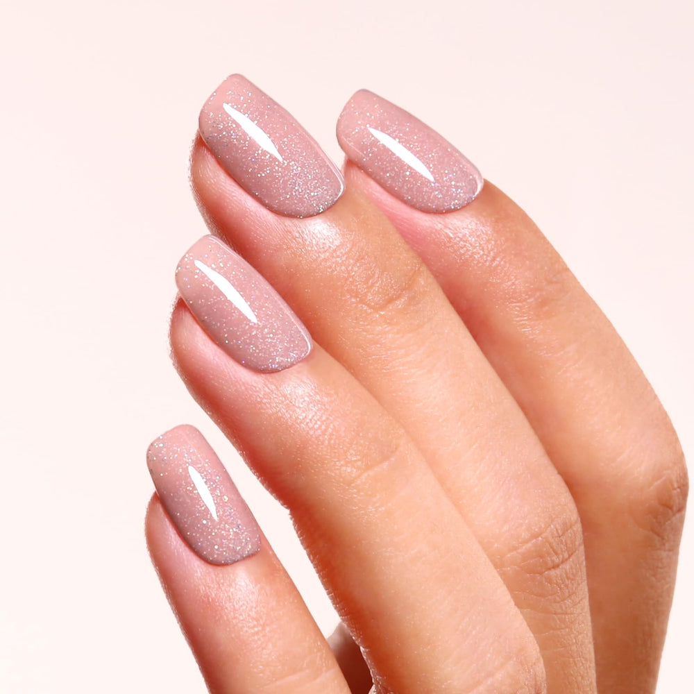 ozzeal swatch on fingers displaying nude mauve pink sparkle, wearable shimmer reference