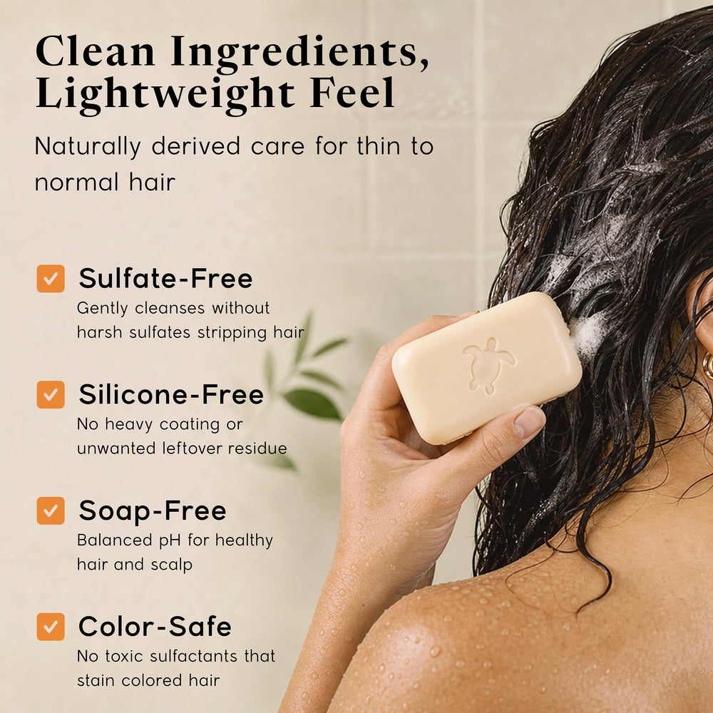 Pacific Spirit shampoo bar in hand applying to wet hair showing easy application benefit