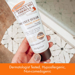 Palmer's scrub being massaged onto skin at sink to remove dead skin and impurities