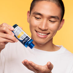 PanOxyl droplet on fingertip ready to apply for targeted pore-penetrating exfoliation